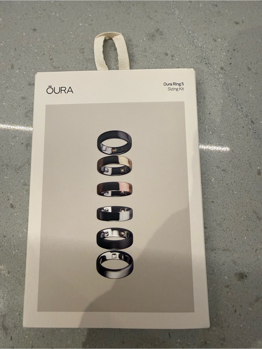 Oura Ring Sizing Kit with Black and Rose Gold Ring Images